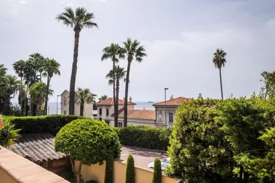 a view from the balcony of a house with palm trees at Résidence Superbe Villa Avec Piscine & Sauna - Superbe villa avec piscine & sauna MAE-2283 in Cannes