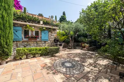 a garden with a stone house with plants on it at Résidence Superbe Villa Avec Piscine & Sauna - Superbe villa avec piscine & sauna MAE-2283 in Cannes