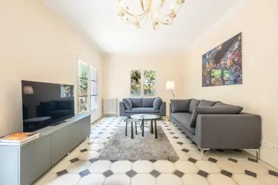 a living room with a couch and a tv at Résidence Superbe Villa Avec Piscine & Sauna - Superbe villa avec piscine & sauna MAE-2283 in Cannes