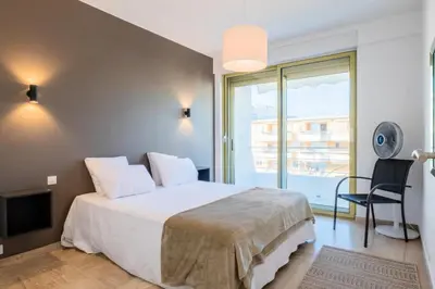 a bedroom with a large bed and a balcony at Résidence Vue Mer Panoramique - 3 Pièces Mouré Rouge - VUE MER PANORAMIQUE - 3 pièces Mouré Rouge MAE-2293 in Cannes