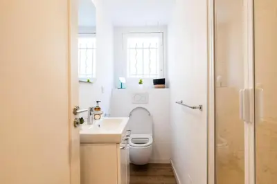a bathroom with a toilet and a sink and a window at Résidence 4p De Style à Deux Pas Du Palais Des Festivals - 4P de style à deux pas du Palais des festivals MAE-2303 in Cannes