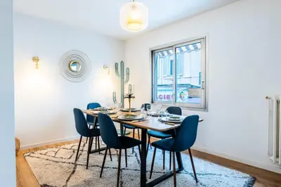 a dining room with a table and chairs and a window at Résidence 4p De Style à Deux Pas Du Palais Des Festivals - 4P de style à deux pas du Palais des festivals MAE-2303 in Cannes