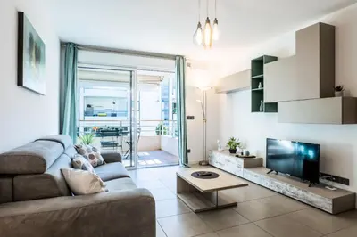 a living room with a couch and a flat screen tv at Résidence 2p Avec Piscine Au Palm Beach - 2P avec piscine au Palm Beach MAE-2313 in Cannes