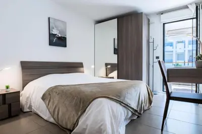a bedroom with a bed and a desk and a table at Résidence 2p Avec Piscine Au Palm Beach - 2P avec piscine au Palm Beach MAE-2313 in Cannes