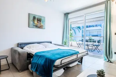 a bedroom with a bed and a large window at Résidence 2p Avec Piscine Au Palm Beach - 2P avec piscine au Palm Beach MAE-2313 in Cannes