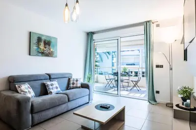 a living room with a couch and a table at Résidence 2p Avec Piscine Au Palm Beach - 2P avec piscine au Palm Beach MAE-2313 in Cannes