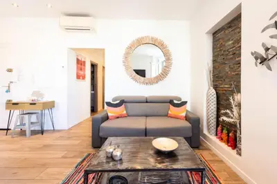 a living room with a couch and a table at Résidence Hyper Centre, Croisette, Plages Et Palais à Pied - Hyper centre, Croisette, plages et Palais à pied MAE-2333 in Cannes