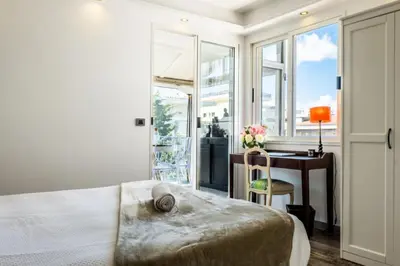 a bedroom with a bed and a desk and a window at Résidence Duplex En Toit-terrasse à Deux Pas De La Croisette - Duplex en toit-terrasse à deux pas de la Croisette MAE-2383 in Cannes