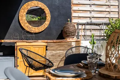 a dining room with a table and chairs and a mirror at Résidence 2p Cozy Avec Jardin En Plein Coeur Du Palm Beach - 2P cozy avec jardin en plein coeur du Palm Beach MAE-2403 in Cannes