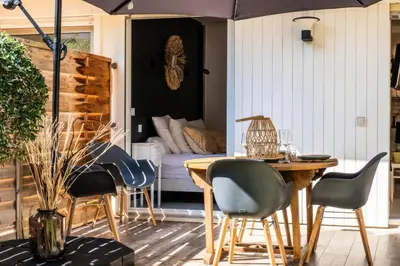 a patio with a table and chairs and a couch at Résidence 2p Cozy Avec Jardin En Plein Coeur Du Palm Beach - 2P cozy avec jardin en plein coeur du Palm Beach MAE-2403 in Cannes