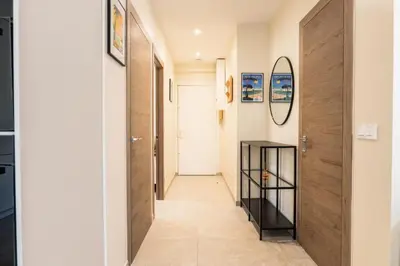 a hallway with a wooden door and a mirror at Résidence Rare ! Rez-de-jardin 10 Minutes à Pied Du Centre - RARE ! Rez-de-jardin 10 minutes à pied du centre MAE-2413 in Cannes