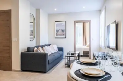 a living room with a couch and a table at Résidence Rare ! Rez-de-jardin 10 Minutes à Pied Du Centre - RARE ! Rez-de-jardin 10 minutes à pied du centre MAE-2413 in Cannes