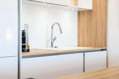a kitchen with white cabinets and a sink at Résidence 3p De Standing, Piscine, Vue Mer, à 2 Pas Des Plages - 3P de standing, piscine, vue mer, à 2 pas des plages MAE-2423 in Cannes
