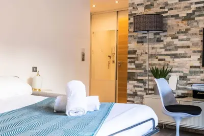 a bedroom with a bed and a desk and a chair at Résidence Rare ! Studio Avec Terrasse à 5 Min à Pied Du Palais - Rare ! Studio avec terrasse à 5 min à pied du Palais MAE-2433 in Cannes
