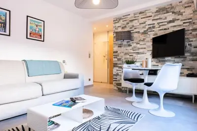a living room with a couch and a table at Résidence Rare ! Studio Avec Terrasse à 5 Min à Pied Du Palais - Rare ! Studio avec terrasse à 5 min à pied du Palais MAE-2433 in Cannes