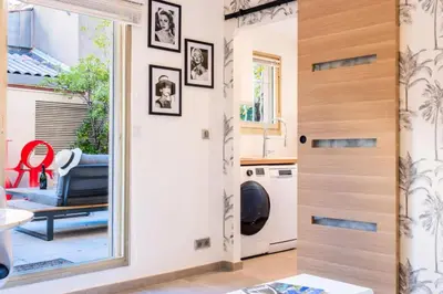 a kitchen with a washer and dryer in a room at Résidence Rare ! Studio Avec Terrasse à 5 Min à Pied Du Palais - Rare ! Studio avec terrasse à 5 min à pied du Palais MAE-2433 in Cannes