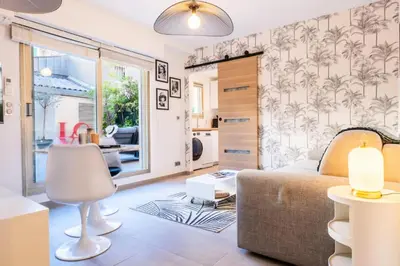 a bedroom with a bed and a living room at Résidence Rare ! Studio Avec Terrasse à 5 Min à Pied Du Palais - Rare ! Studio avec terrasse à 5 min à pied du Palais MAE-2433 in Cannes