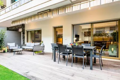 an outdoor patio with a dining table and chairs at Résidence 3p Centre-ville Avec Jardin, 1min De La Croisette - 3P centre-ville avec jardin, 1min de la Croisette MAE-2443 in Cannes