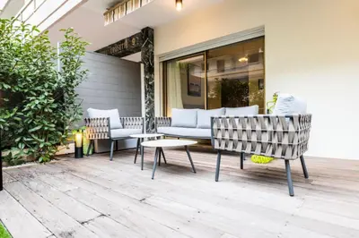 a patio with two chairs and a couch and a table at Résidence 3p Centre-ville Avec Jardin, 1min De La Croisette - 3P centre-ville avec jardin, 1min de la Croisette MAE-2443 in Cannes