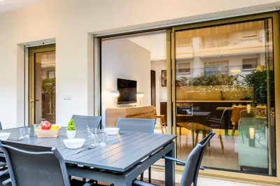 a dining room with a table and chairs at Résidence 3p Centre-ville Avec Jardin, 1min De La Croisette - 3P centre-ville avec jardin, 1min de la Croisette MAE-2443 in Cannes