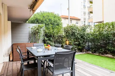 a patio with a table and chairs on a deck at Résidence 3p Centre-ville Avec Jardin, 1min De La Croisette - 3P centre-ville avec jardin, 1min de la Croisette MAE-2443 in Cannes