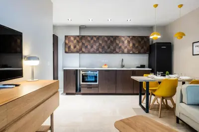 a kitchen and living room with a table and a couch at Résidence 3p Centre-ville Avec Jardin, 1min De La Croisette - 3P centre-ville avec jardin, 1min de la Croisette MAE-2443 in Cannes