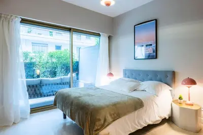 a bedroom with a bed and a large window at Résidence 3p Centre-ville Avec Jardin, 1min De La Croisette - 3P centre-ville avec jardin, 1min de la Croisette MAE-2443 in Cannes