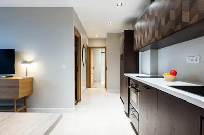 a kitchen with wooden cabinets and a counter top at Résidence 3p Centre-ville Avec Jardin, 1min De La Croisette - 3P centre-ville avec jardin, 1min de la Croisette MAE-2443 in Cannes