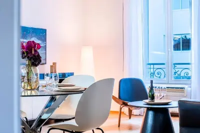 a dining room with chairs and a table with a vase of flowers at Résidence 3p Haut-de-gamme à 200m Des Plages Croisette - 3p haut-de-gamme à 200m des plages Croisette MAE-2453 in Cannes