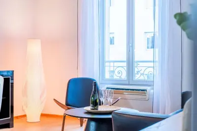 a living room with a table and chairs and a window at Résidence 3p Haut-de-gamme à 200m Des Plages Croisette - 3p haut-de-gamme à 200m des plages Croisette MAE-2453 in Cannes