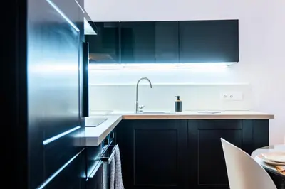 a kitchen with black cabinets and a sink at Résidence 3p Haut-de-gamme à 200m Des Plages Croisette - 3p haut-de-gamme à 200m des plages Croisette MAE-2453 in Cannes