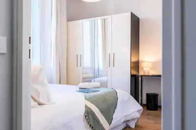 a bedroom with a white bed and a large mirror at Résidence 3p Haut-de-gamme à 200m Des Plages Croisette - 3p haut-de-gamme à 200m des plages Croisette MAE-2453 in Cannes