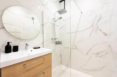 a bathroom with a shower with a sink and a mirror at Résidence Appartement Moderne En Plein Centre Ville ! - Appartement moderne en plein centre ville ! MAE-2463 in Cannes