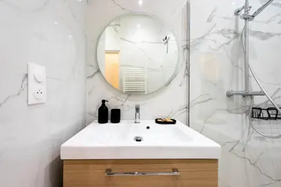 a bathroom with a white sink and a mirror at Résidence Appartement Moderne En Plein Centre Ville ! - Appartement moderne en plein centre ville ! MAE-2463 in Cannes
