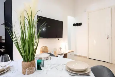 a dining room with a table with glasses and a plant at Résidence Appartement Moderne En Plein Centre Ville ! - Appartement moderne en plein centre ville ! MAE-2463 in Cannes