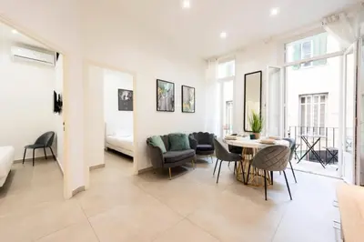 a living room with a table and chairs at Résidence Appartement Moderne En Plein Centre Ville ! - Appartement moderne en plein centre ville ! MAE-2463 in Cannes