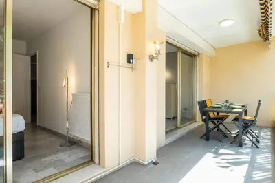 a room with a table and a dining room at Résidence 2p Avec Terrasse, Vue Mer Et Parking - 2P avec terrasse, vue mer et parking MAE-2483 in Cannes