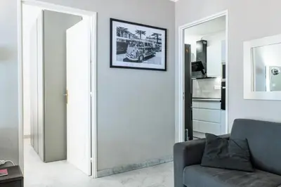 a living room with a couch and a picture on the wall at Résidence 2p Avec Terrasse, Vue Mer Et Parking - 2P avec terrasse, vue mer et parking MAE-2483 in Cannes