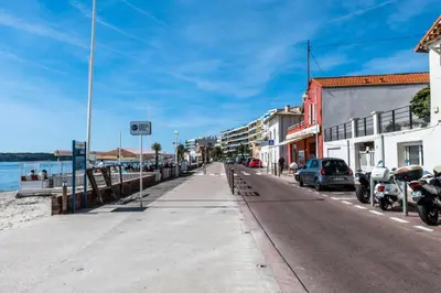 a street with cars parked on the side of a beach at Résidence 2p Avec Terrasse, Vue Mer Et Parking - 2P avec terrasse, vue mer et parking MAE-2483 in Cannes