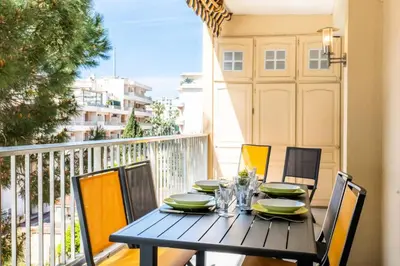 a black table and chairs on a balcony at Résidence 2p Avec Terrasse, Vue Mer Et Parking - 2P avec terrasse, vue mer et parking MAE-2483 in Cannes