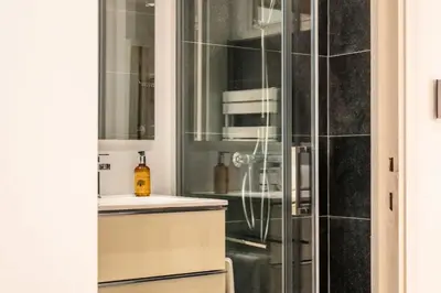 a bathroom with a glass shower with a sink at Résidence 3p Lumineux Avec Terrasse à 15min à Pied Du Palais - 3P lumineux avec terrasse à 15min à pied du Palais MAE-2493 in Cannes