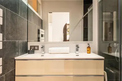a bathroom with a sink and a mirror at Résidence 3p Lumineux Avec Terrasse à 15min à Pied Du Palais - 3P lumineux avec terrasse à 15min à pied du Palais MAE-2493 in Cannes