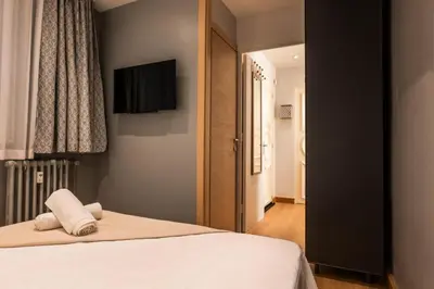 a bedroom with a bed with a television on the wall at Résidence 3p Lumineux Avec Terrasse à 15min à Pied Du Palais - 3P lumineux avec terrasse à 15min à pied du Palais MAE-2493 in Cannes