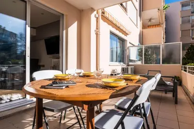 a dining room with a wooden table and chairs at Résidence 3p Lumineux Avec Terrasse à 15min à Pied Du Palais - 3P lumineux avec terrasse à 15min à pied du Palais MAE-2493 in Cannes
