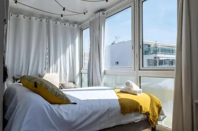 a bedroom with a bed and a large window at Résidence 3p Rooftop Palm Beach, Plages à 2min à Pied - 3P Rooftop Palm Beach, plages à 2min à pied MAE-2503 in Cannes