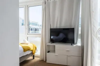a bedroom with a tv on a white dresser at Résidence 3p Rooftop Palm Beach, Plages à 2min à Pied - 3P Rooftop Palm Beach, plages à 2min à pied MAE-2503 in Cannes