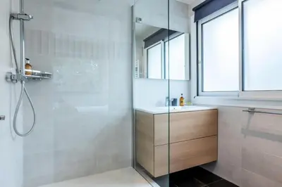 a bathroom with a shower with a sink and a glass door at Résidence 2 Pièces Terrasse à 8min à Pied Du Centre Parking - 2 pièces terrasse à 8min à pied du centre parking MAE-2553 in Cannes