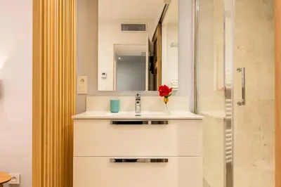 a white bathroom with a sink and a mirror at Résidence 3p Haut-de-gamme à 300m Des Plages Croisette - 3p haut-de-gamme à 300m des plages Croisette MAE-2563 in Cannes