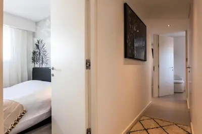 a bedroom with a bed and a hallway at Résidence 4 Pièces Vue Mer, Terrasse Et Parking - 4 pièces vue mer, terrasse et parking MAE-2573 in Cannes