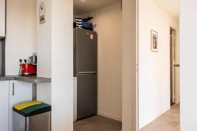 a kitchen with a refrigerator in a room at Résidence 4p Avec Terrasse Vue Mer à Deux Pas Des Plages - 4P avec terrasse vue mer à deux pas des plages MAE-2593 in Cannes